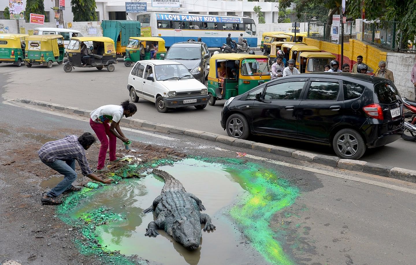 An installation where a crocodile comes out of one of the potholes. | | @royalbaadal | Facebook