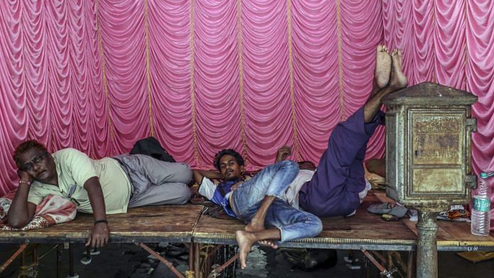 People take break at shed for upcoming festival in Mumbai, India, on Thursday, Aug. 29, 2019. | Photographer: Dhiraj Singh | Bloomberg