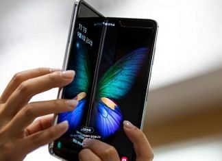 Representational image. An employee holds a Samsung Electronics Co. Galaxy Fold smartphone at the company's D'light flagship store in Seoul, South Korea | Photo: SeongJoon Cho | Bloomberg