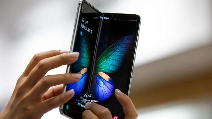 Representational image. An employee holds a Samsung Electronics Co. Galaxy Fold smartphone at the company's D'light flagship store in Seoul, South Korea | Photo: SeongJoon Cho | Bloomberg