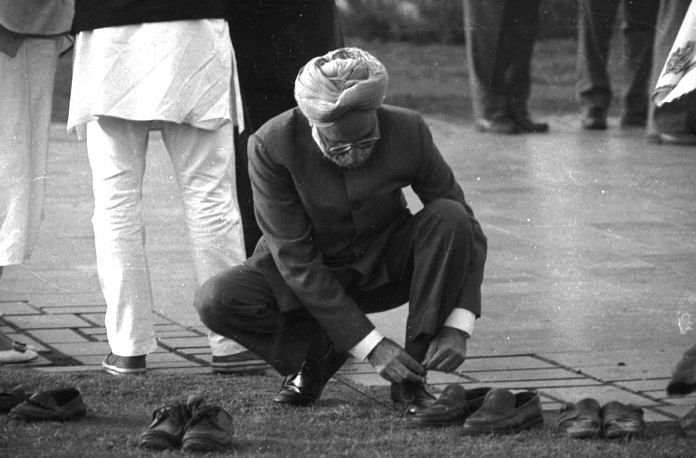 Manmohan Singh ties his shoe laces at Rajiv Gandhi's memorial Veer Bhumi much before he became a prime minister. | Photo: Praveen Jain | ThePrint