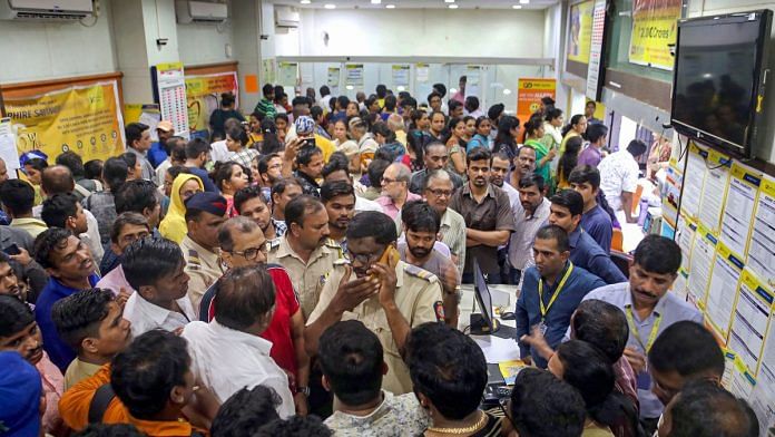 Customers gather inside the Punjab and Maharashtra Cooperative Bank, at Kolshet in Thane