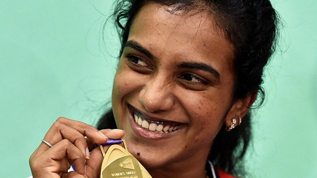 PV Sindhu shows her gold medal during a press conference in Hyderabad on 27 August