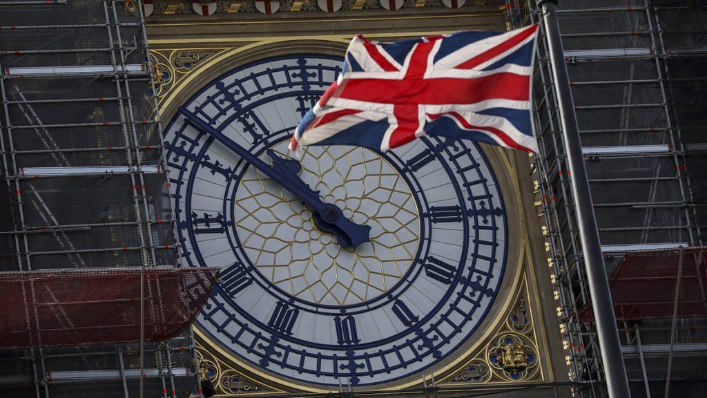 A British Union flag, also known as a Union Jack, flies in front of the clock face on the Elizabeth Tower in London on 28 August