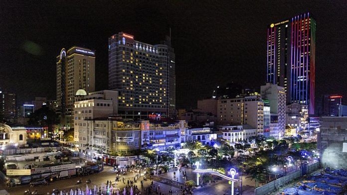 Commercial buildings in downtown district being illuminated at night in Ho Chi Minh, Vietnam | Photographer: Ore Huiying | Bloomberg