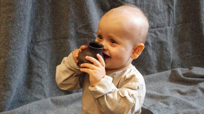 A baby testing a replica of one of the ancient bottles. | Helena Seidl da Fonseca, Author provided