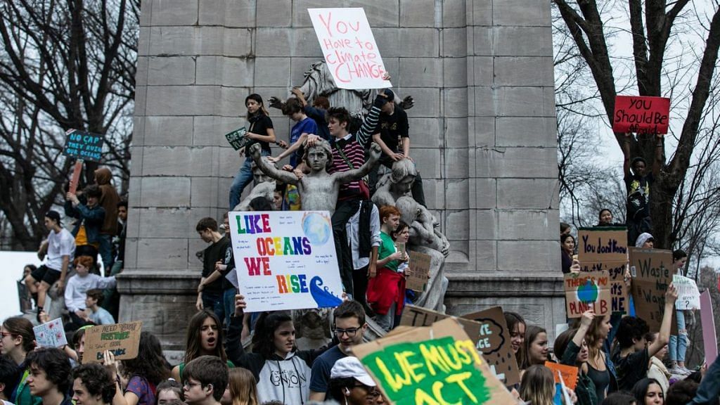 Demonstrators hold signs during the U.S. Youth Climate Strike in New York, U.S. | Photographer: Jeenah Moon | Bloomberg