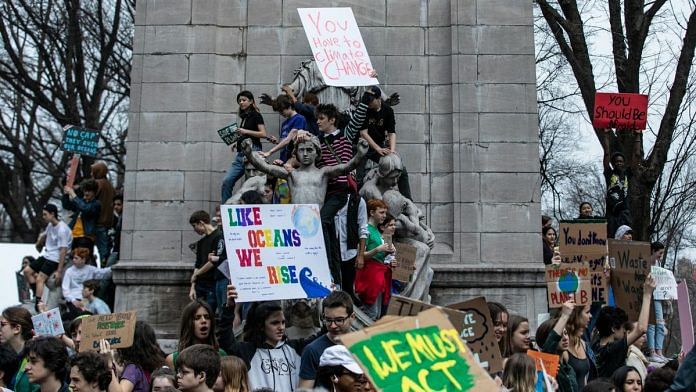 Demonstrators hold signs during the U.S. Youth Climate Strike in New York, U.S. | Photographer: Jeenah Moon | Bloomberg