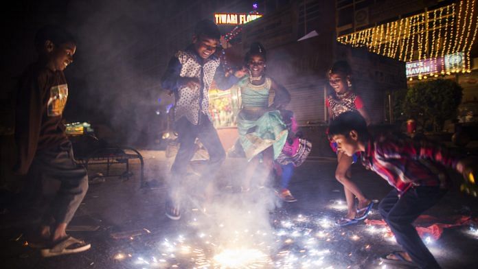 Children set off a firework during Diwali celebrations in Delhi | Photographer: Prashanth Vishwanathan | Bloomberg