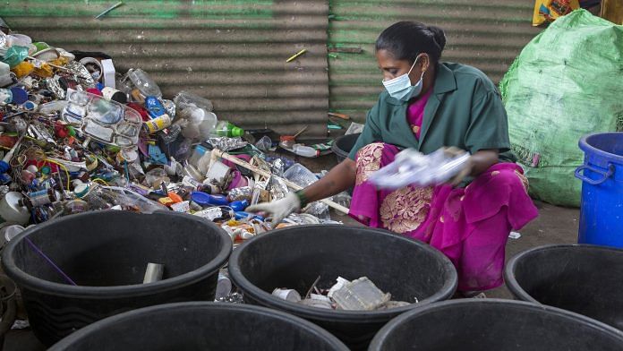 A worker sorts plastic household waste at a warehouse in a recycling facility operated by Mysuru City Corp. in Mysuru, Karnataka, India. | Photo: Samyukta Lakshmi | Bloomberg