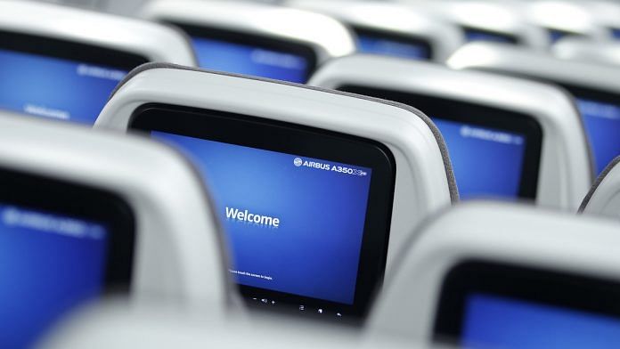 In-flight entertainment screens in the economy class cabin of an Airbus A350 XWB aircraft. | Photographer: Kiyoshi Ota | Bloomberg