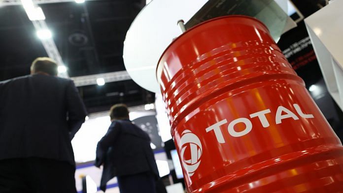 The logo of Total SA sits on an oil drum in the corporate hall at the St Petersburg International Economic Forum (SPIEF) in Saint Petersburg | Photographer: Andrey Rudakov | Bloomberg