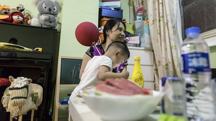 Zou Xiaoqi plays with her two year old son, Shanghai | Bloomberg