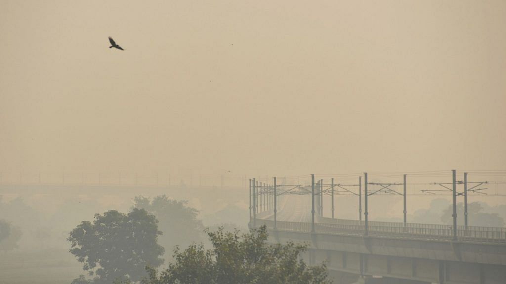 Delhi metro running amid dense haze and low visibility, in New Delhi.