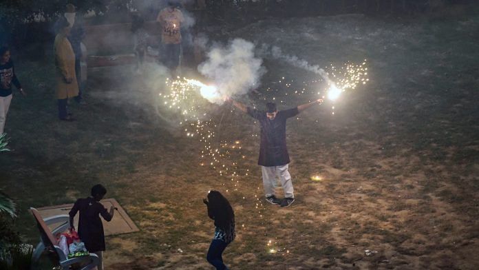 Smoke rises as people burn crackers during 'Diwali' celebrations, in New Delhi. | PTI