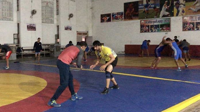Wrestlers during a practice session at Jat College akhara in Rohtak | ThePrint | Deeksha Bhardwaj