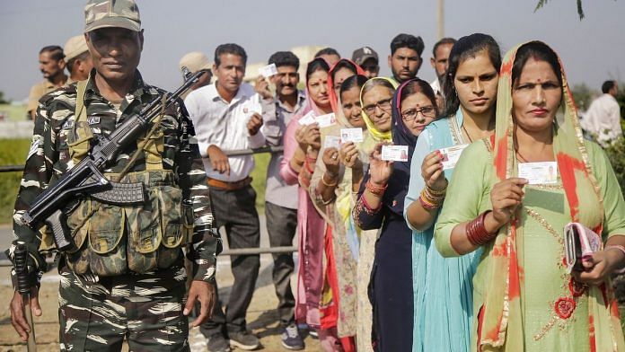 Panches and Sarpanches stand in a queue to cast their votes for Block Development Councils elections at Suchetgarh near international border in Jammu and Kashmir Thursday