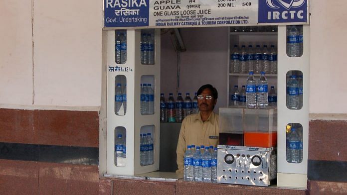 A vendor selling Rail Neer plastic water bottles at Jaipur Junction