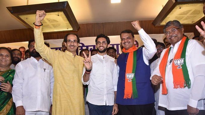 Shiv Sena's Uddhav and Aditya Thackeray with BJP's Devendra Fadnavis after announcing poll alliance for Maharashtra assembly election