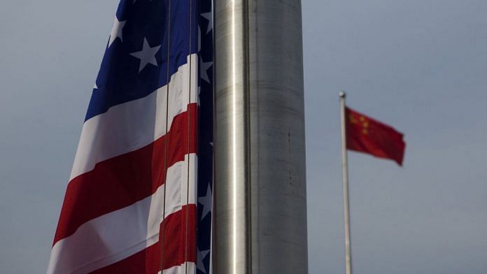 The US flag is seen next to the Chinese Flag in Beijing