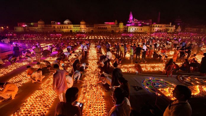 Devotees light earthen lamps on the bank of Saryu River during Deepotsav celebrations in Ayodhya