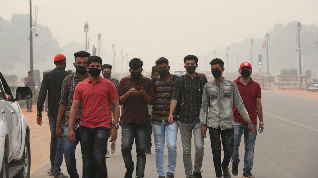 People wear face masks to protect against the severely bad air quality in Delhi. Pollution levels spiked to alarming levels after Diwali, with the EPCA declaring a public health emergency | Suraj Singh Bish | ThePrint