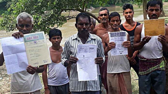 People show their documents as their names weren't included from the NRC