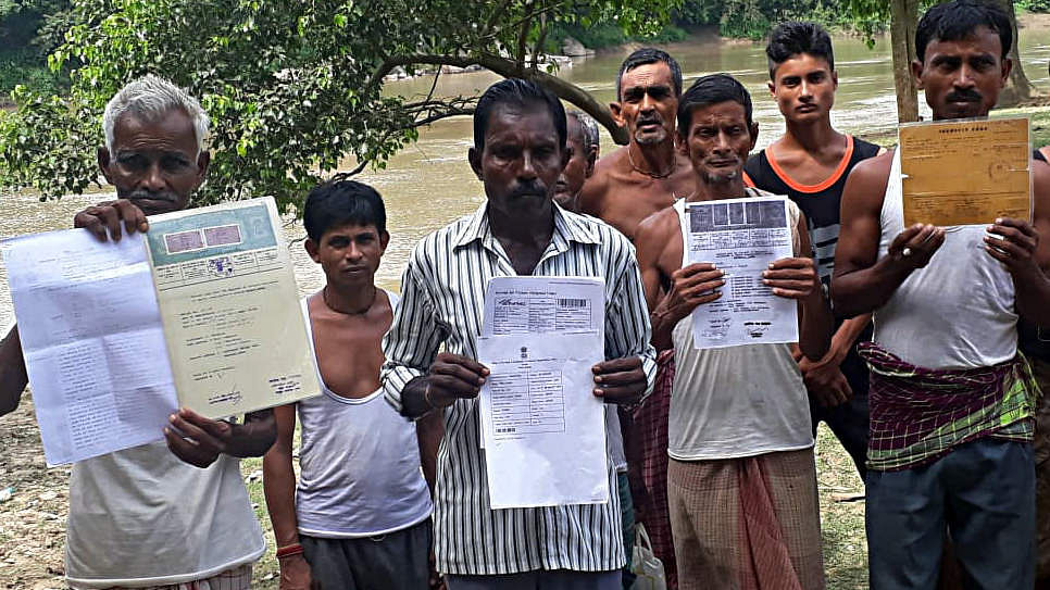 People show their documents as their names weren't included from the NRC
