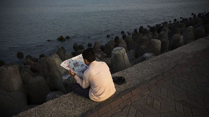 A man reads a newspaper