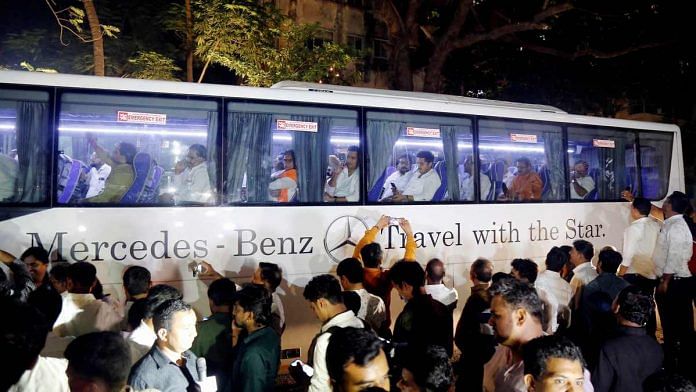 NCP MLAs leave in a bus after a meeting with party MLA's in Mumbai on 23 November