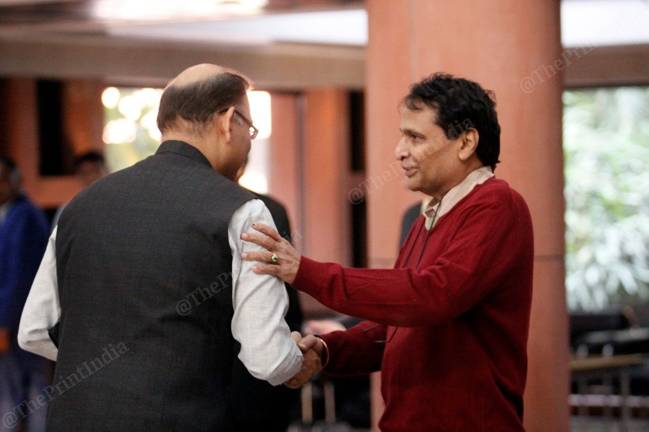 Former Union Ministers Suresh Prabhu greets Jayant Sinha outside Parliament