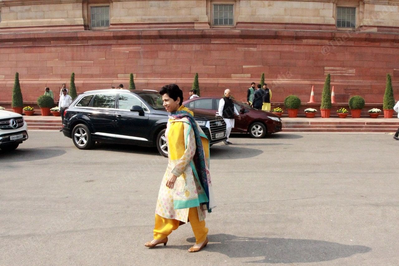 Congress party leader and Rajya Sabha MP Kumari Selja in a yellow printed cloth, walks towards her car