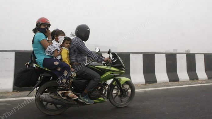 A family travels through the smog on the outskirts of Delhi on 3 November | Praveen Jain | ThePrint