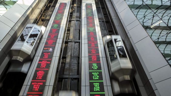 Electronic board indicates the latest stock figures at the the National Stock Exchange in Mumbai. | Photographer: Dhiraj Singh | Bloomberg