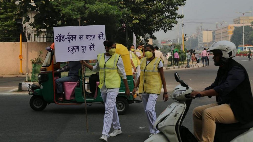 Volunteers hold placards reminding drivers to follow the odd-even rule in New Delhi. | Photo: Suraj Singh Bisht | ThePrint
