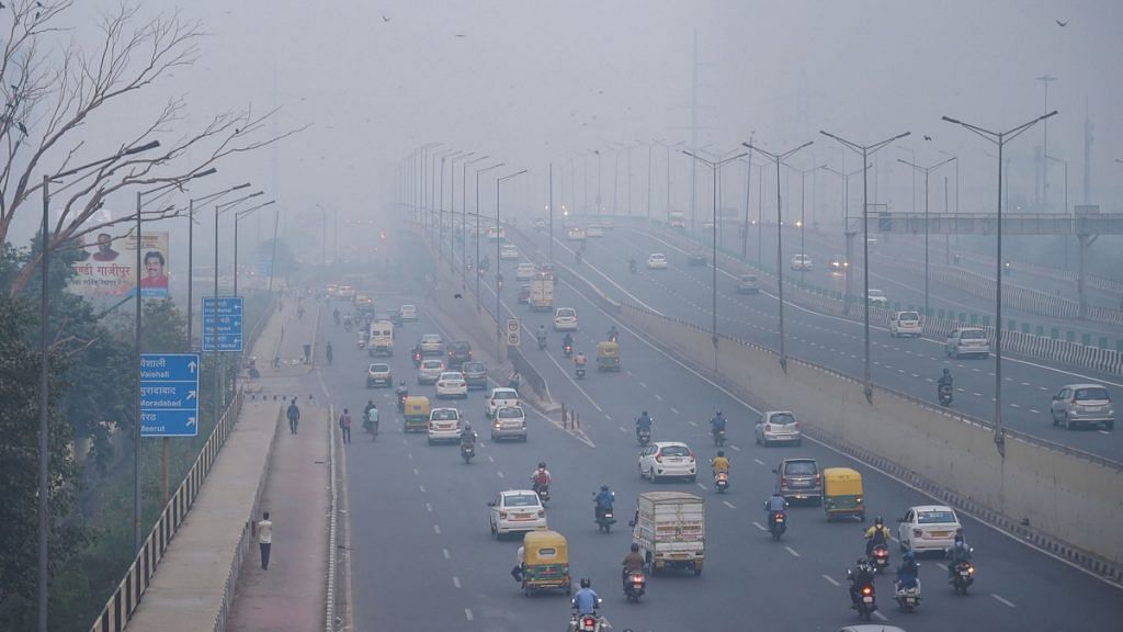 Vehicles ply amid an atmosphere shrouded in smog in New Delhi | PTI