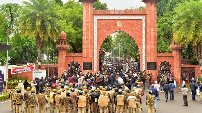 Police personnel stand guard outside Aligarh Muslim University as students protest against the passing of Citizenship Amendment Bill | PTI