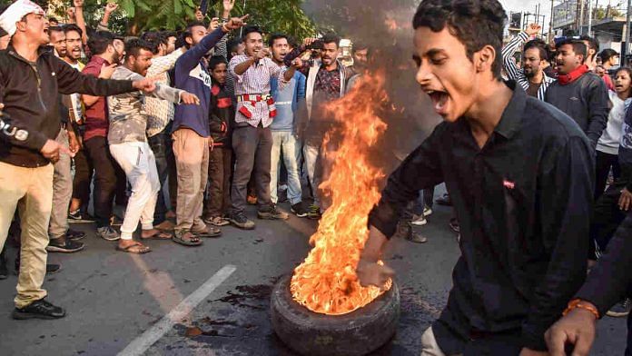 Demonstrators burn tyres during a protest against the Citizenship (Amendment) Bill, in Guwahati Tuesday