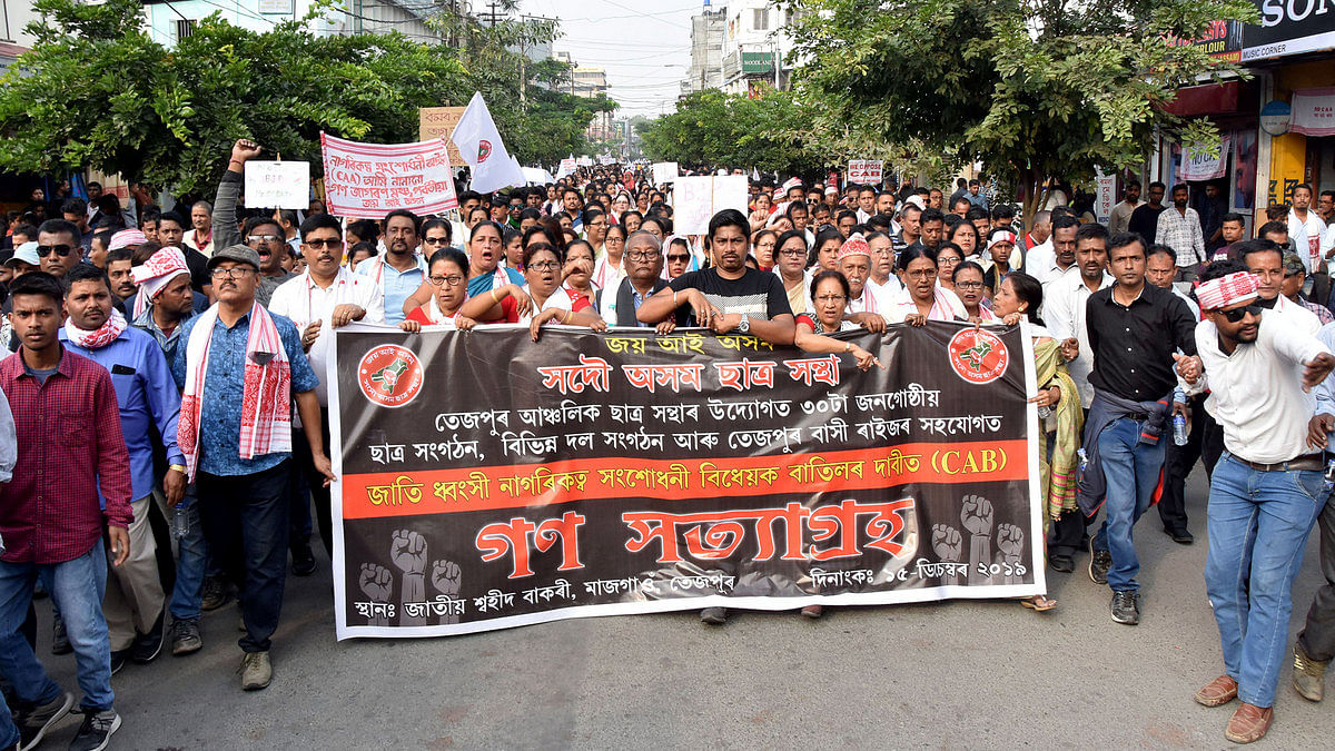 Members of the All Assam Student Union hold a banner during a protest Assam protests