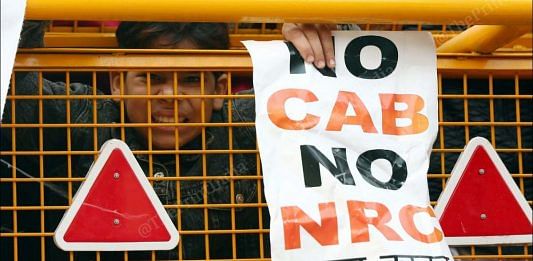 A man holds a placard 'No CAB, No NRC' at a protest against the amended citizenship law in old Delhi on 20 December 2019 | Suraj Singh Bisht | ThePrint Photo