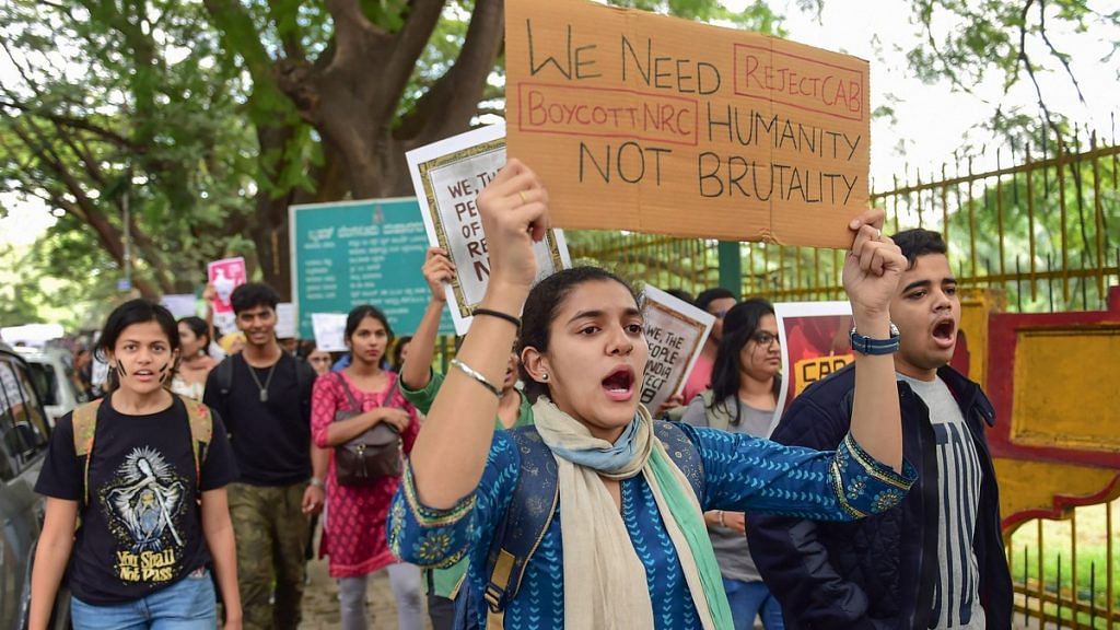 Students raise slogans during a protest against police atrocity and Citizenship Amendment Act, in Bengaluru | PTI