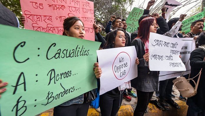 People from northeastern states display placards during their protest against Citizenship Amendment Bill, 2019 at Jantar Mantar in New Delhi. | PTI