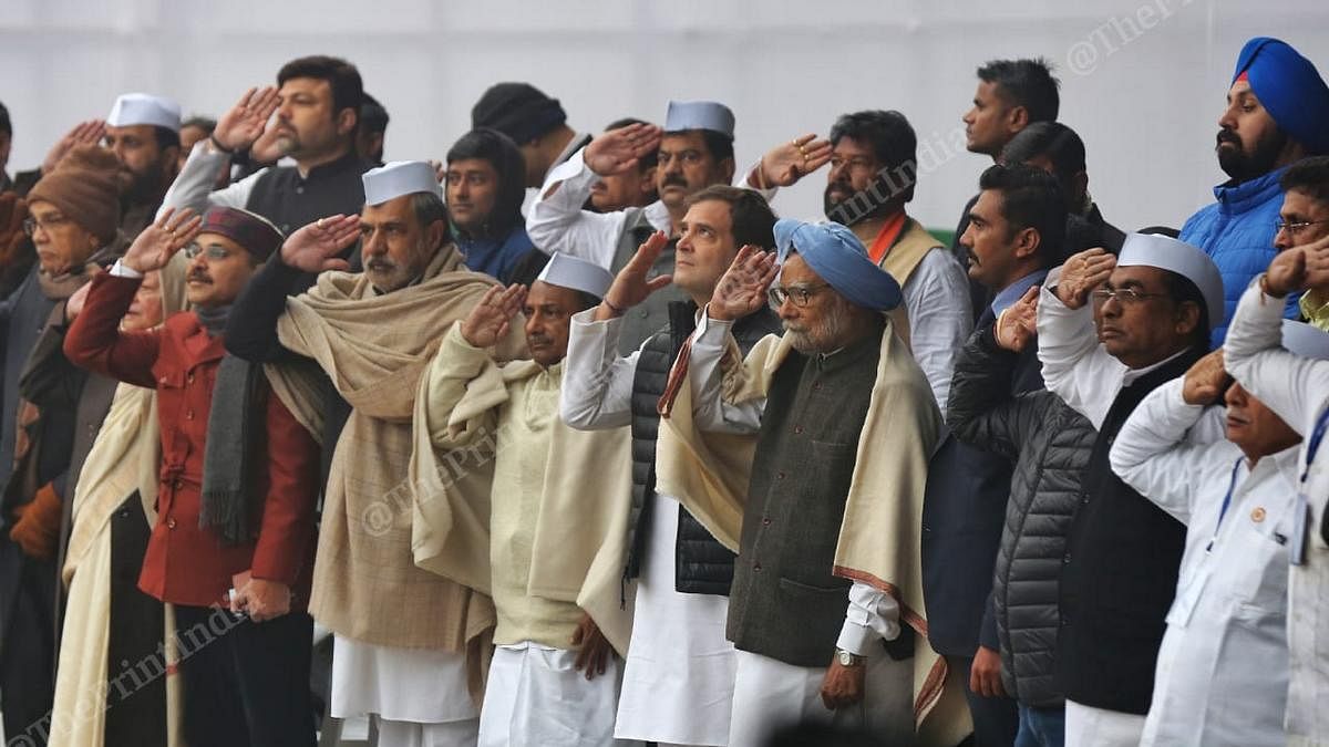 Congress party leaders including Rahul Gandhi and Manmohan Singh at saluting the flag at the Congress foundation day ceremony in New Delhi. | Photo: Suraj Singh Bisht | ThePrint