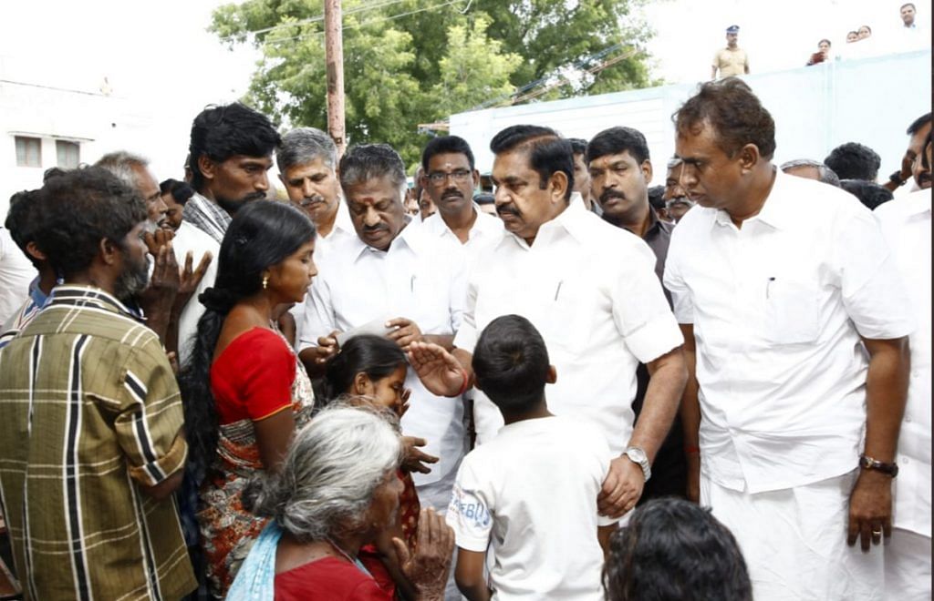 A file photo of Tamil Nadu Chief Minister K. Palaniswami and his deputy O. Panneerselvam meeting the families of those killed in the wall collapse in Coimbatore
