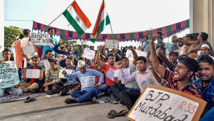CAA: Protest in Hyderabad Maulana Azad National Urdu University students hold placards during a protest in front of the university entrance against Citizenship (Amendment) Act (CAA) and NRC, in Hyderabad,