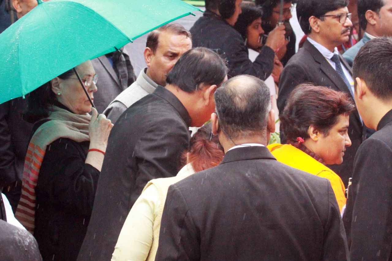 Congress interim chief Sonia Gandhi holds a green umbrella while MP Pragya Thakur passes by | Photo: Praveen Jain | ThePrint