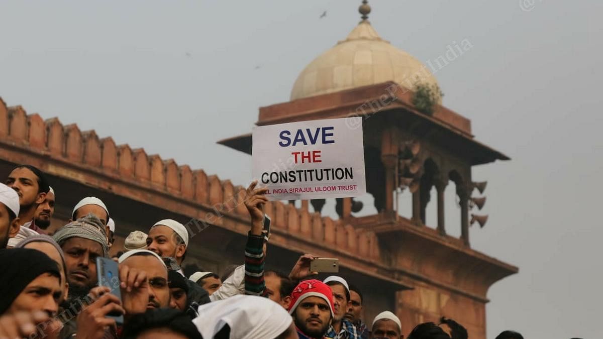 A man holds up a placard that reads 'Save the Constitution' at protest at Jama Masjid in New Delhi on 20 December 2019 | Suraj Singh Bisht | ThePrint Photo