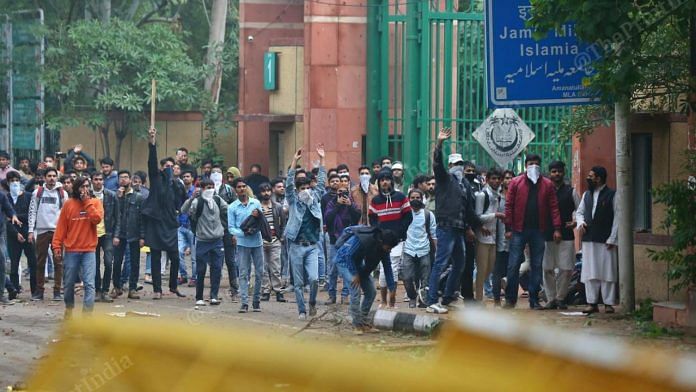 Students outside Jamia Milia Islamia University in New Delhi on 13 December