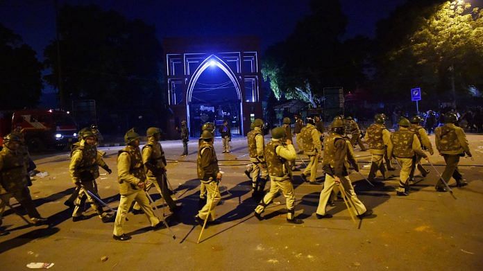 Policemen stand guard near Jamia Millia Islamia following the protests against Citizenship Amendment Act, in New Delhi