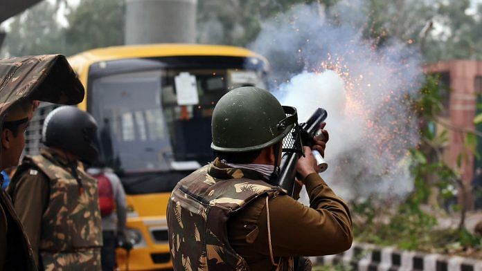 Police personnel fire teargas shells at Delhi's Jamia Millia Islamia Sunday